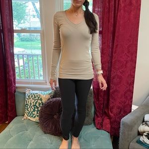 Tan long sleeve, fitted women’s top.